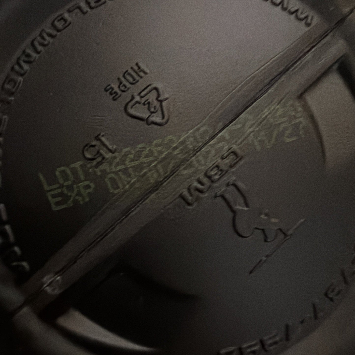 Close-up of a black cast iron skillet with branding and text.