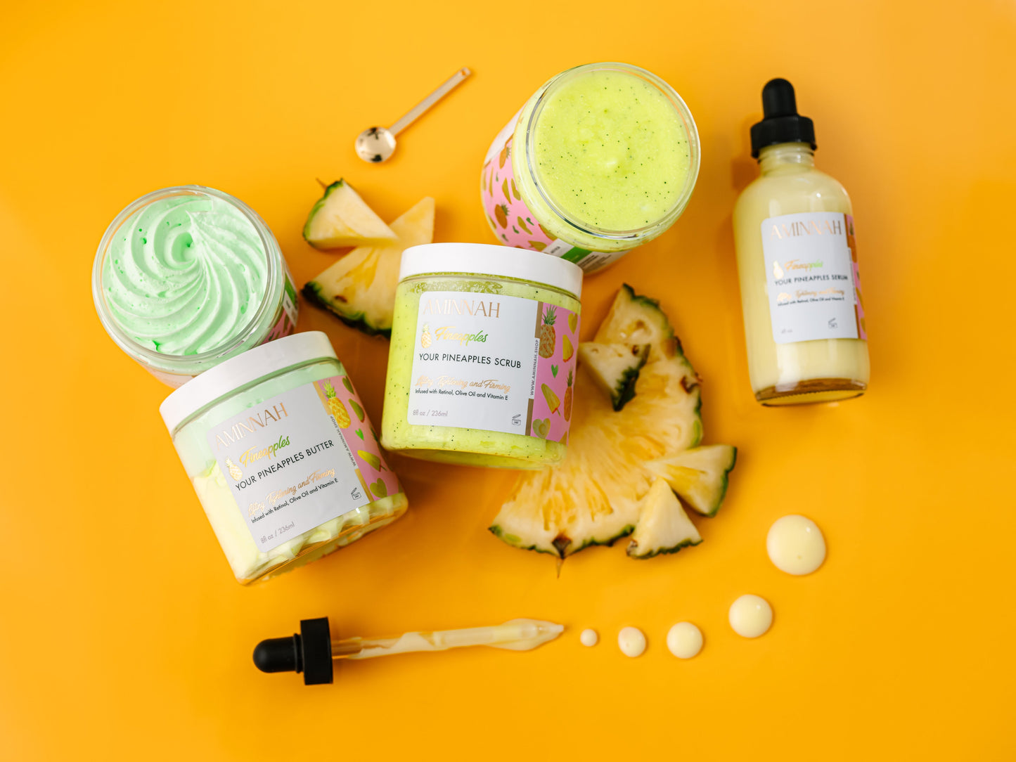 Assorted skincare products with pineapple slices on a bright yellow background