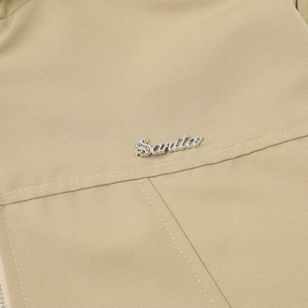 Beige double-sided hooded winter jacket with embroidered logo detail, durable textured fabric, and clean stitched finish. Close-up of premium reversible men's streetwear outerwear.