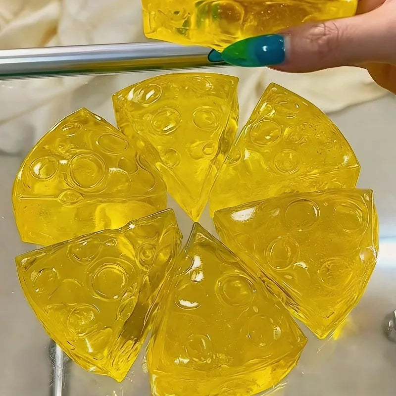 Soft, translucent yellow honey cheese squishy stress relief toy shaped like Swiss cheese slices displayed on a metal rod, sensory fidget squeeze toy for anxiety relief and tactile play. Squishy Toy.