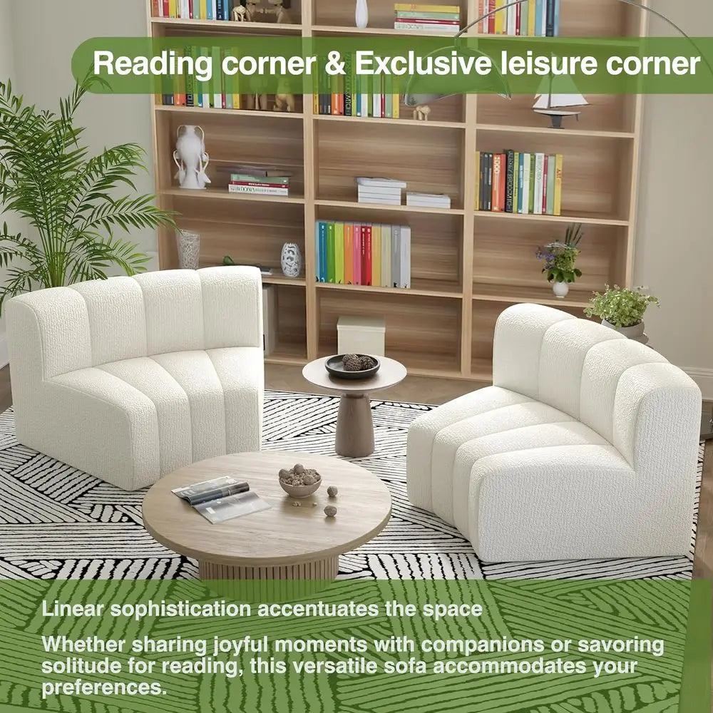 Living room with white sofa, round coffee table, and bookshelf filled with books.