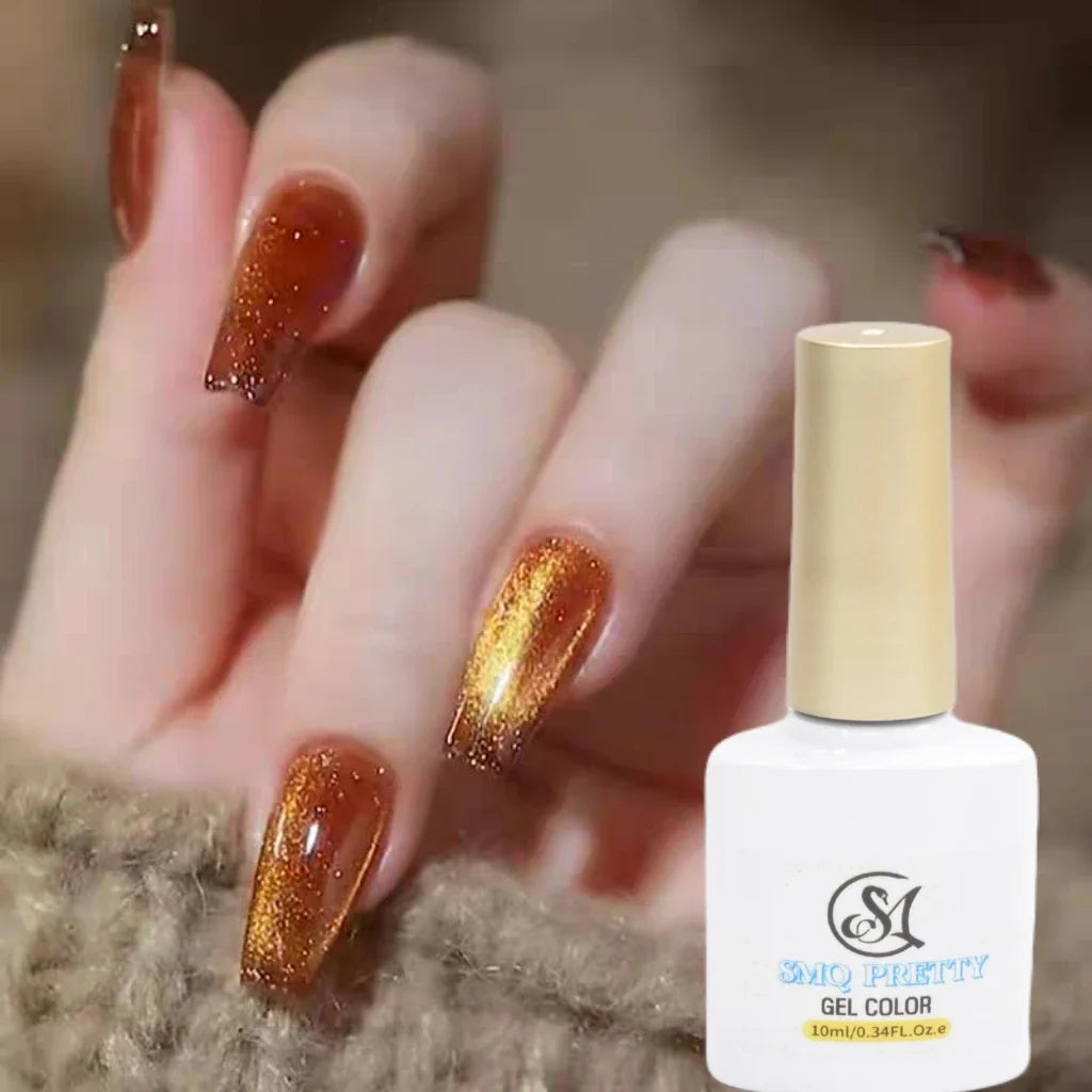 A hand with a professional manicure featuring sparkling orange glitter cat-eye gel polish, held next to a matching 10ml bottle of LUXEBYMIMI magnetic gel nail polish.