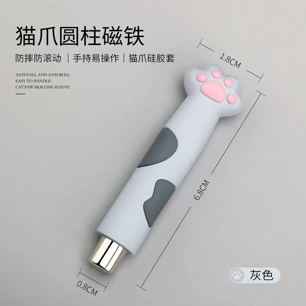 Cat paw-shaped magnetic nail art tool for creating heart patterns, set against a neutral gray background.