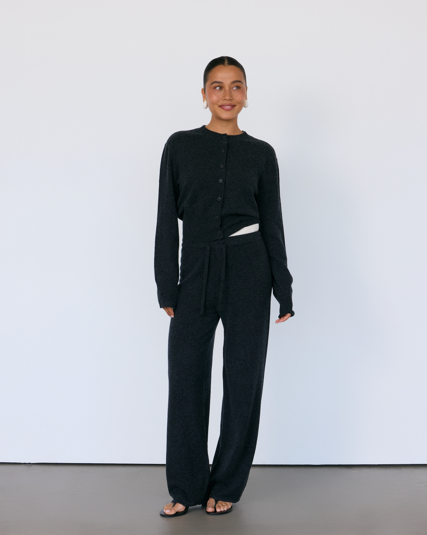 Person wearing a black Cashmere outfit with a white background