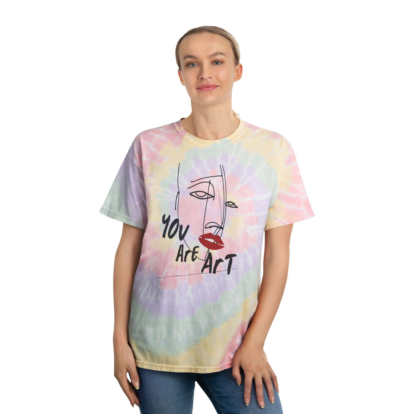 Person wearing a pastel spiral tie-dye unisex T-shirt featuring a minimalist abstract face graphic with "You Are Art" text, standing against a white background. Colorful boho graphic tee ideal for summer, festivals, beach days, casual wear, and unique gift ideas.