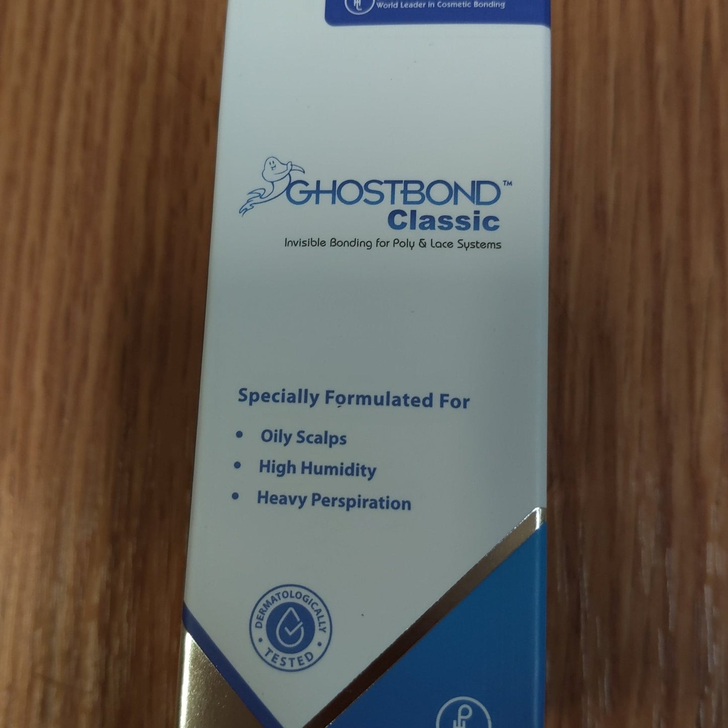 Ghostbond Classic product packaging on a wooden surface. Lace wig bonding glue