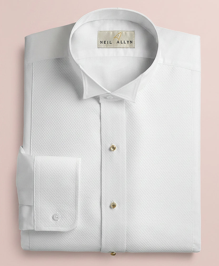 Folded white dress shirt with a visible brand label on a dark background