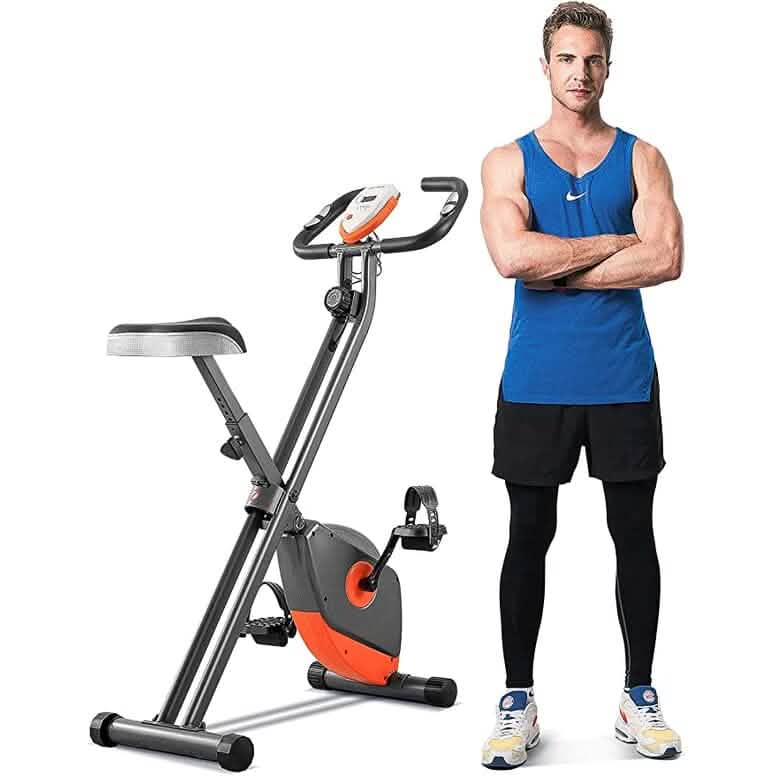 Man standing next to a folding exercise bike on a white background. Maxkare MK-4012 Exercise Bike with Arm Resistance Bands