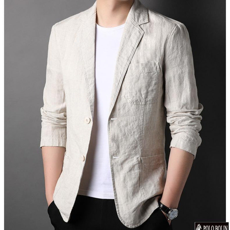 Light beige blazer worn by a person on a dark background