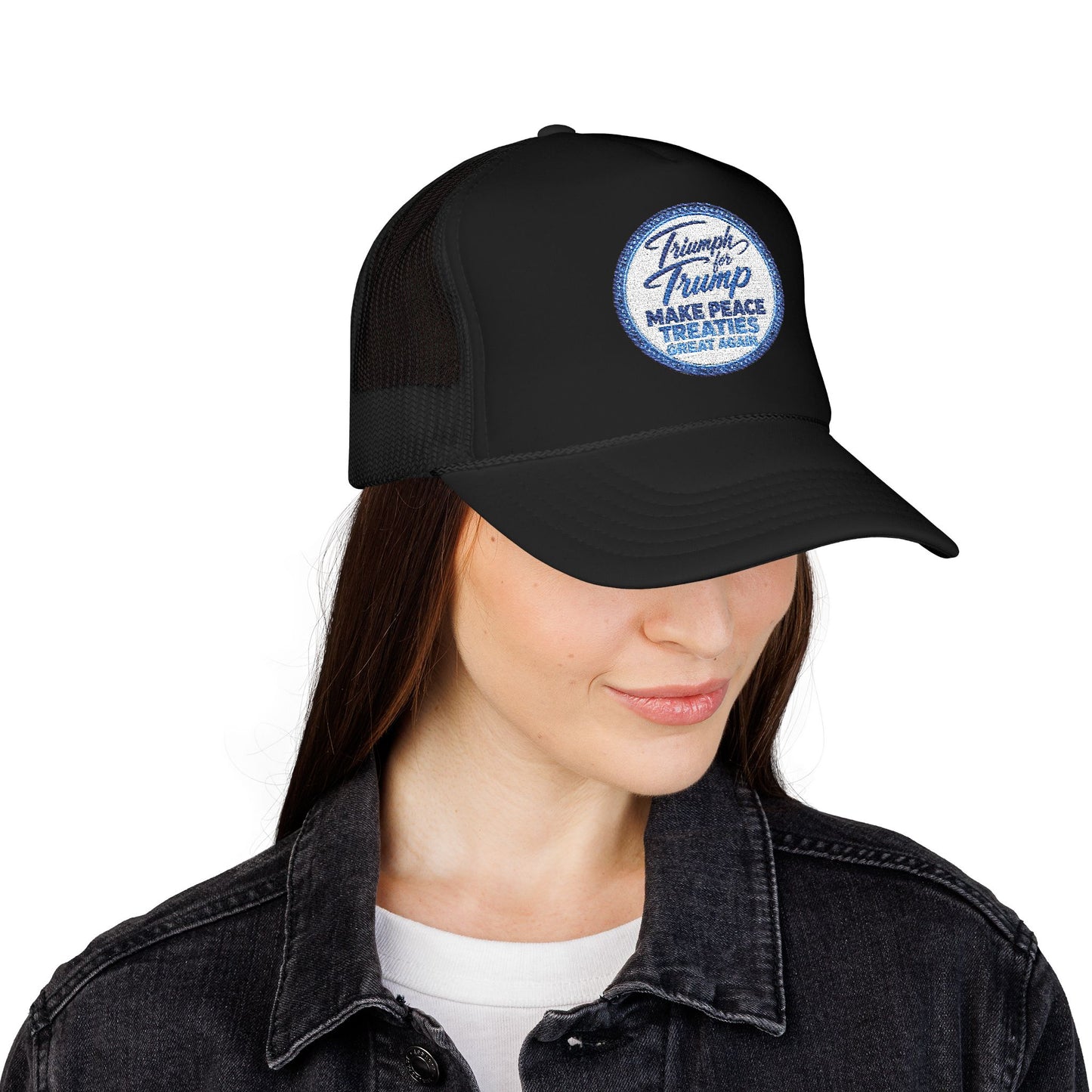 Person wearing a black cap with white text on a white background lack foam trucker hat featuring a vintage embroidered-style "Triumph for Trump – Make Peace Treaties Great Again" campaign patch on a unisex mesh baseball cap.