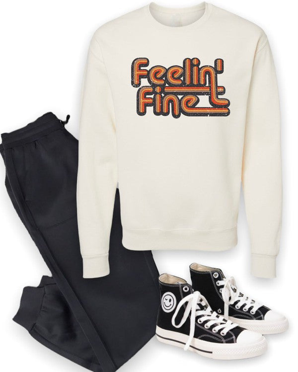 Person wearing a white sweatshirt with 'Feelin' Fine' text in orange and black.