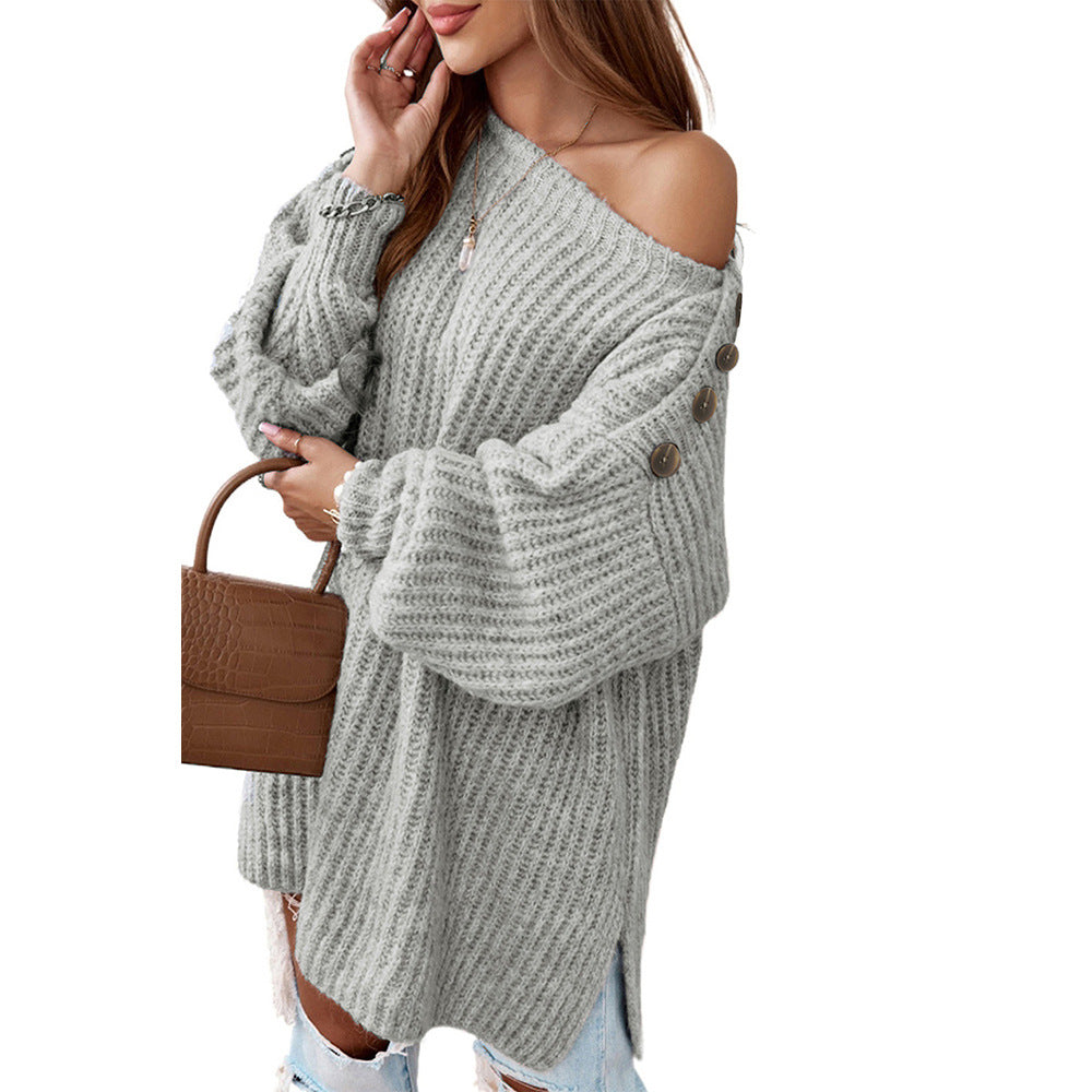Woman wearing a gray off-shoulder knit sweater holding a brown handbag on a white background