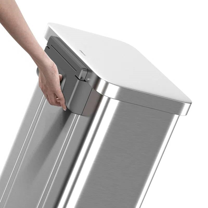 Hand opening a metallic trash can on a white background