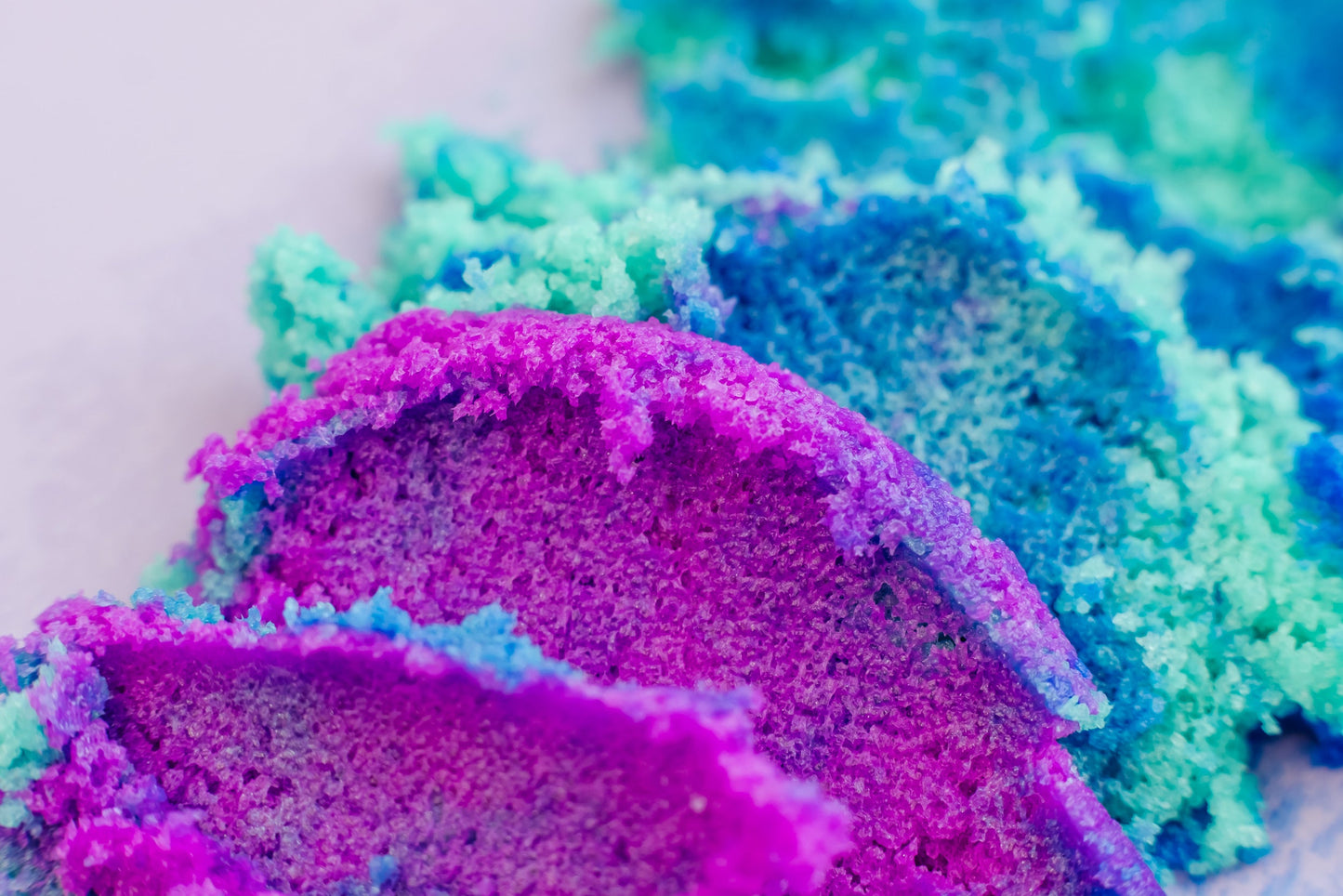 Close-up of colorful bath bomb with purple, blue, and green hues. "Galaxy" Sugar Scrub