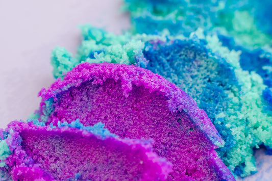 Close-up of colorful bath bomb with purple, blue, and green hues. "Galaxy" Sugar Scrub