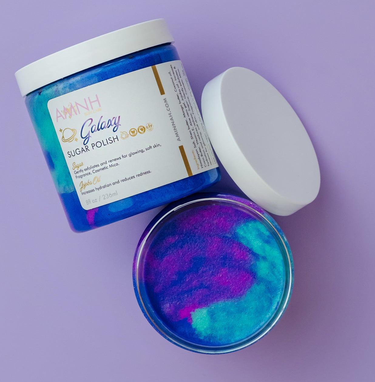 "Galaxy" Sugar Scrub-Jar of 'Galaxy Sugar Polish' with colorful powder on a white background. Galaxy teal, purple and blue organic sugar scrub with only natural ingredients. Gentle exfoliator clean beauty.