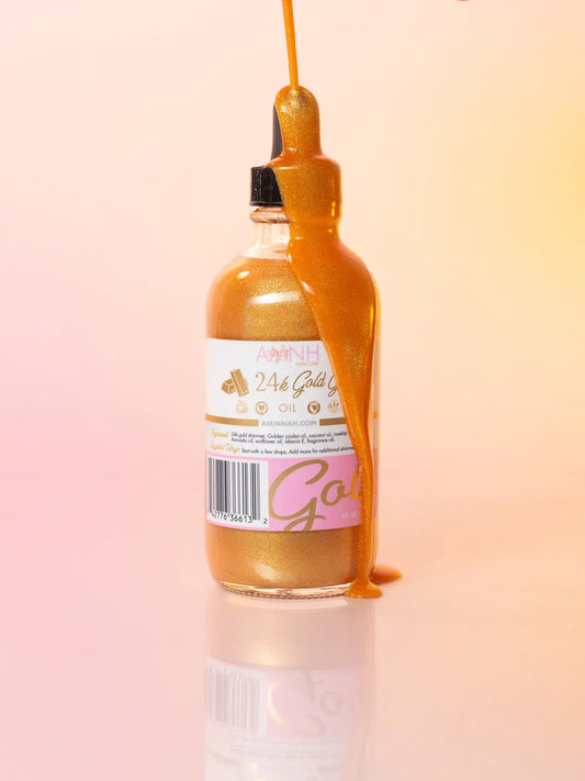 24K Gold Glow Body Oil by AMINNAH in a glass bottle with shimmering gold body oil and dropper, moisturizing skincare for radiant glowing skin.