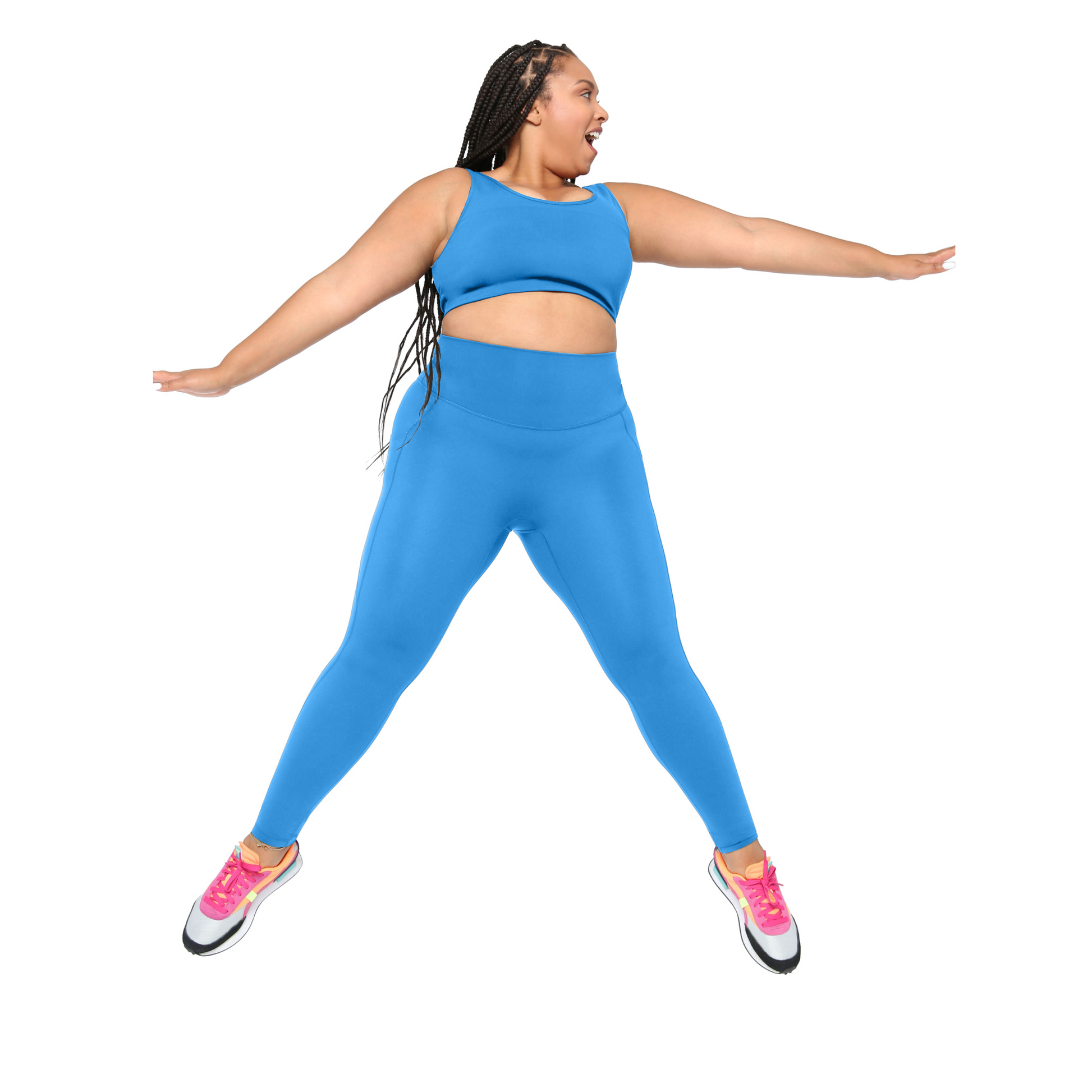 plus size Woman wearing a blue athletic outfit with pink sneakers on a white background