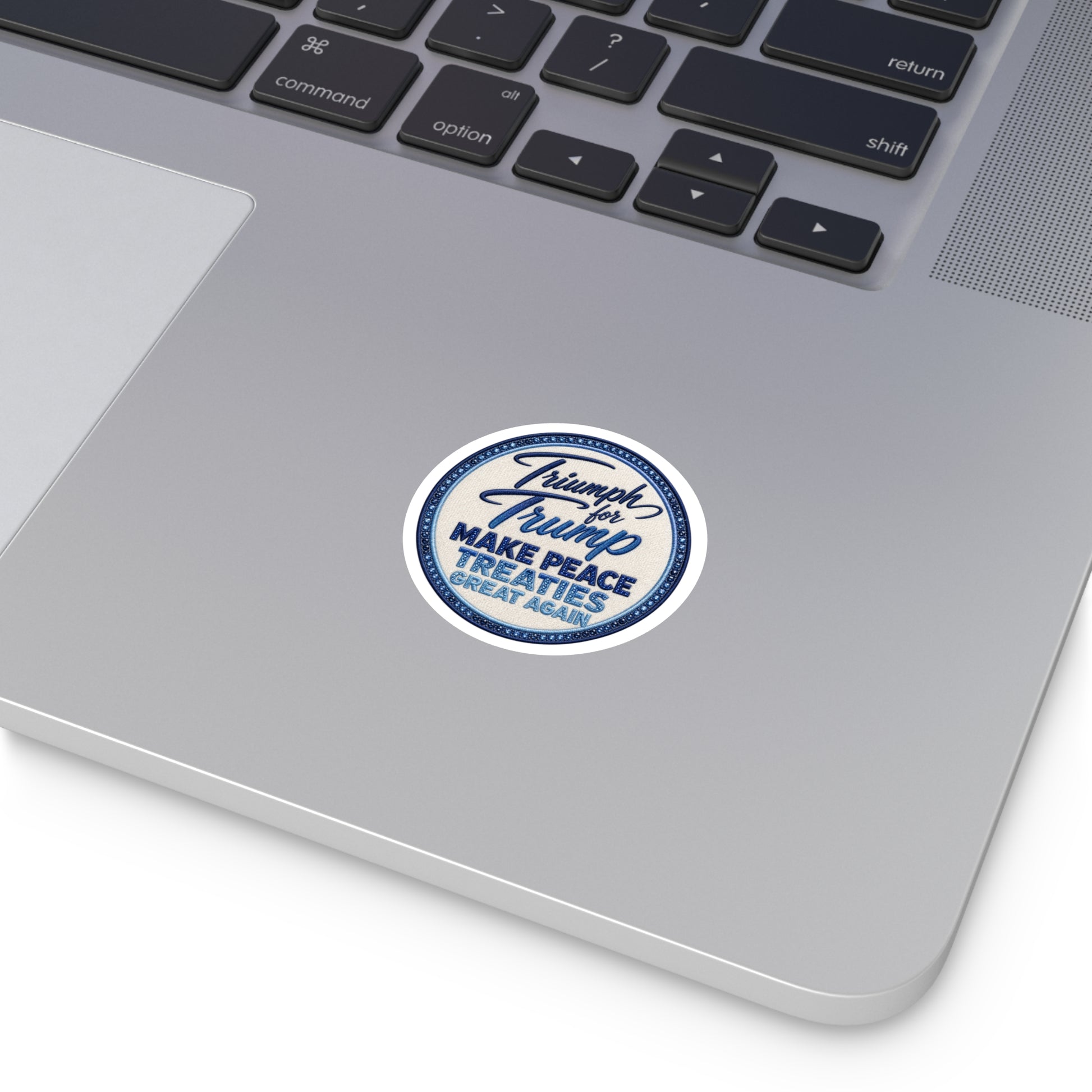 Laptop with a sticker on the palm rest area Round Political Sticker — “Make Peace Treaties Great Again”