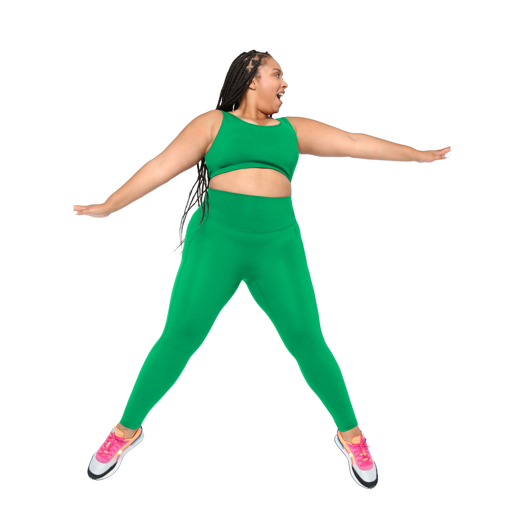 Plus size Woman wearing a green outfit with pink shoes on a white background