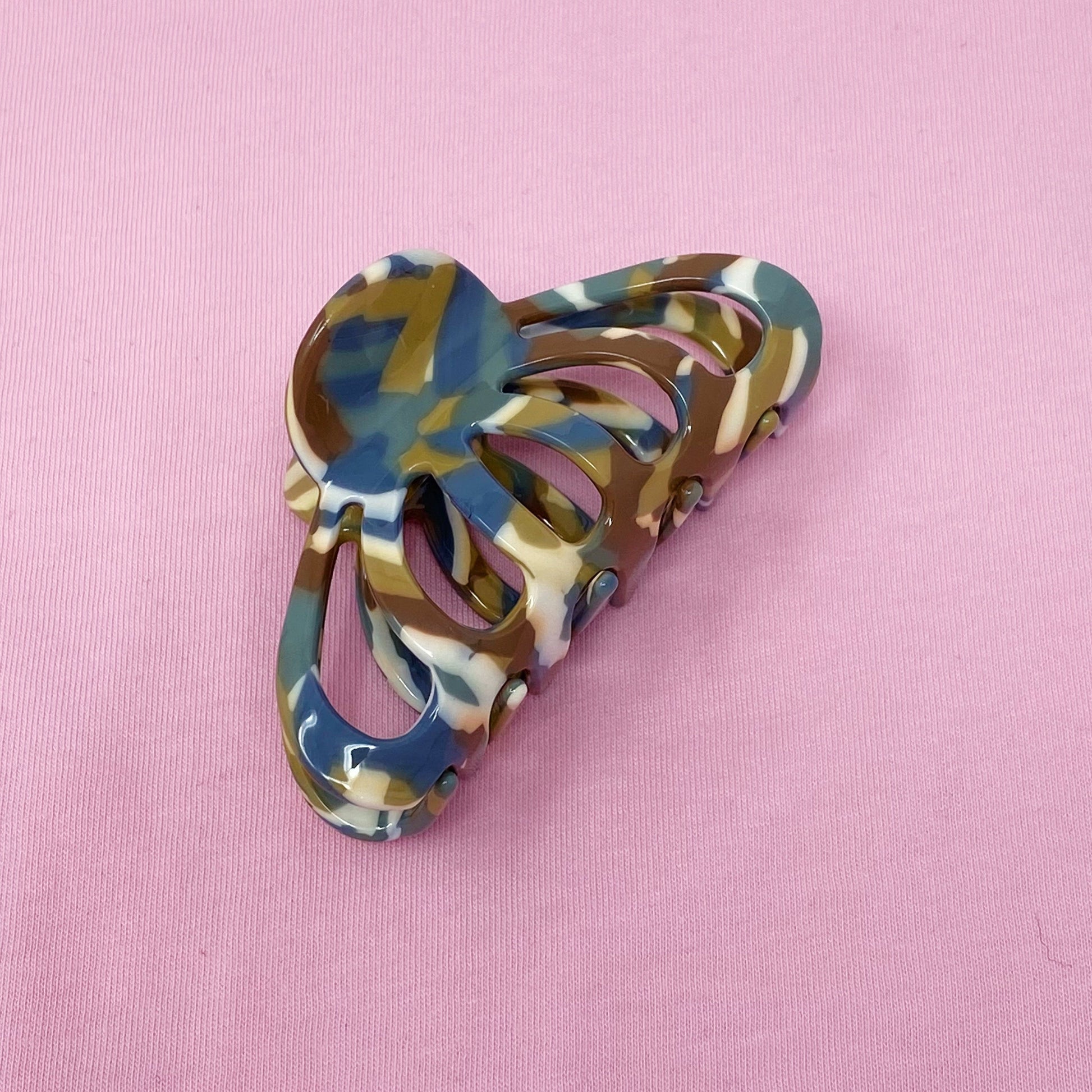 Multicolored hair clip on a pink background