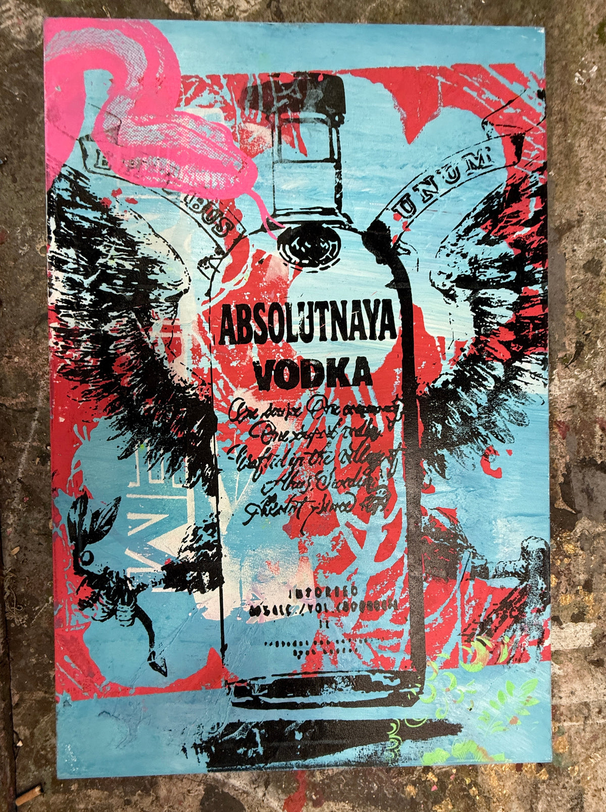 A square art print or poster featuring a stylized Absolutnaya Vodka bottle illustration in black over a bright blue background, with bold red paint splatters and pink flamingo shapes. The print is photographed against a textured brown surface. ABSOLUTNAYA - Silk Screen & Spray Paint on canvas, 2025