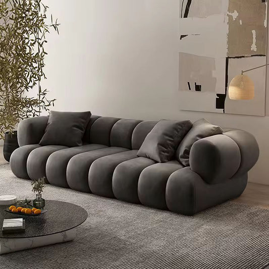 Gray sofa in a modern living room with a plant and abstract art on the wall. ATUNUS American Large Velvet Home Furniture Nordic Modern L Shape Corner Living Room Modular Sectional Sofa Couch Set
