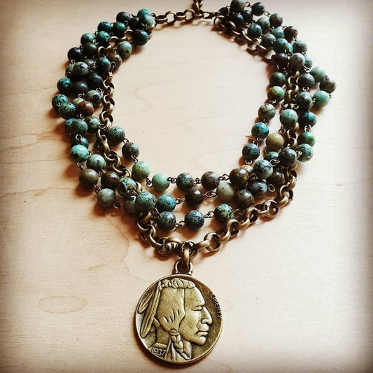 African Turquoise Collar Length Necklace with Indian Head Coin Elevate your necklace game with this stunning African turquoise and antique gold collar that doubles as the perfect layering piece. Genuine African turquoise stones catch the light beautifully, while an authentic Indian head coin adds vintage charm and character. At 18 inches with a 2.5-inch extender, this choker-length necklace transitions effortlessly from solo statement to layered masterpiece. Whether you're channeling boho vibes or mixing 