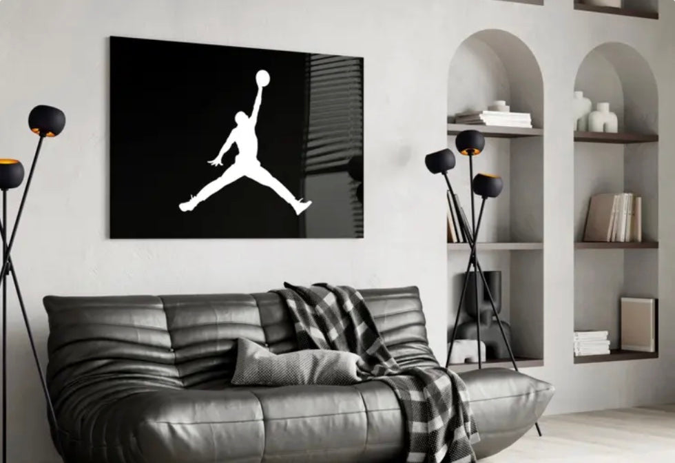 Modern living room with a large abstract painting of lips and an American flag, a gray sofa, and decorative shelves. Michael Jordan Air Jordan Glass Wall Art Piece for Collectors Sports art for hanging on a wall. Glossy Wall Art Piece