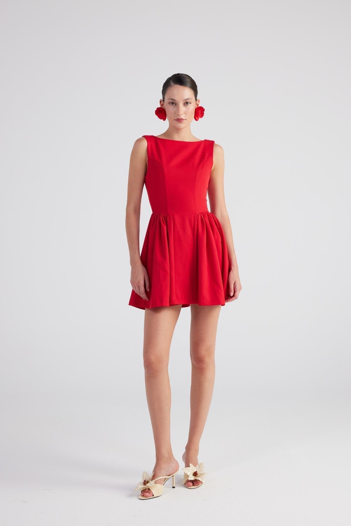 Woman wearing a red dress on a white background