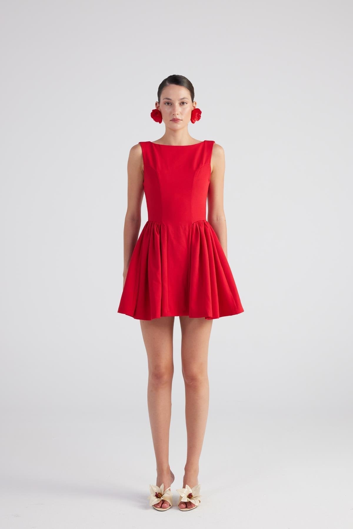 Woman wearing a red dress on a white background