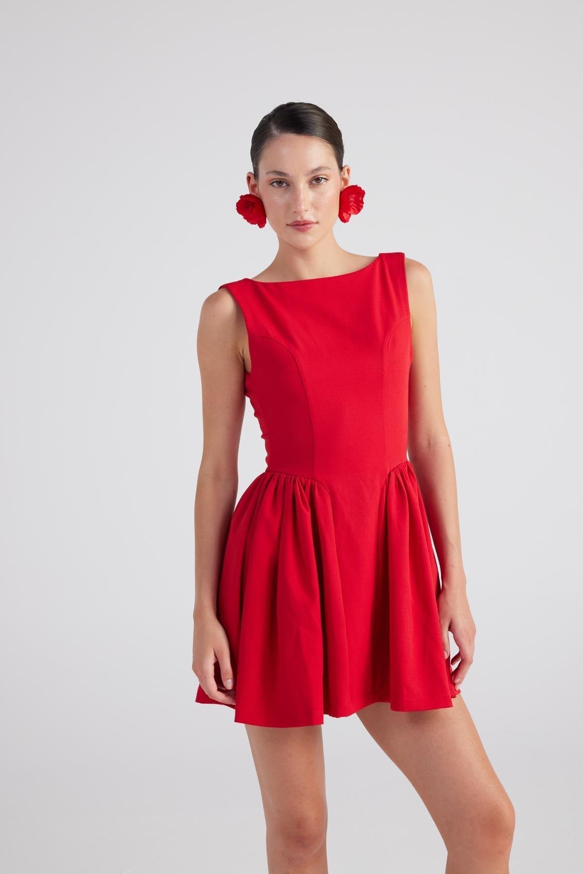 Woman wearing a red dress on a white background