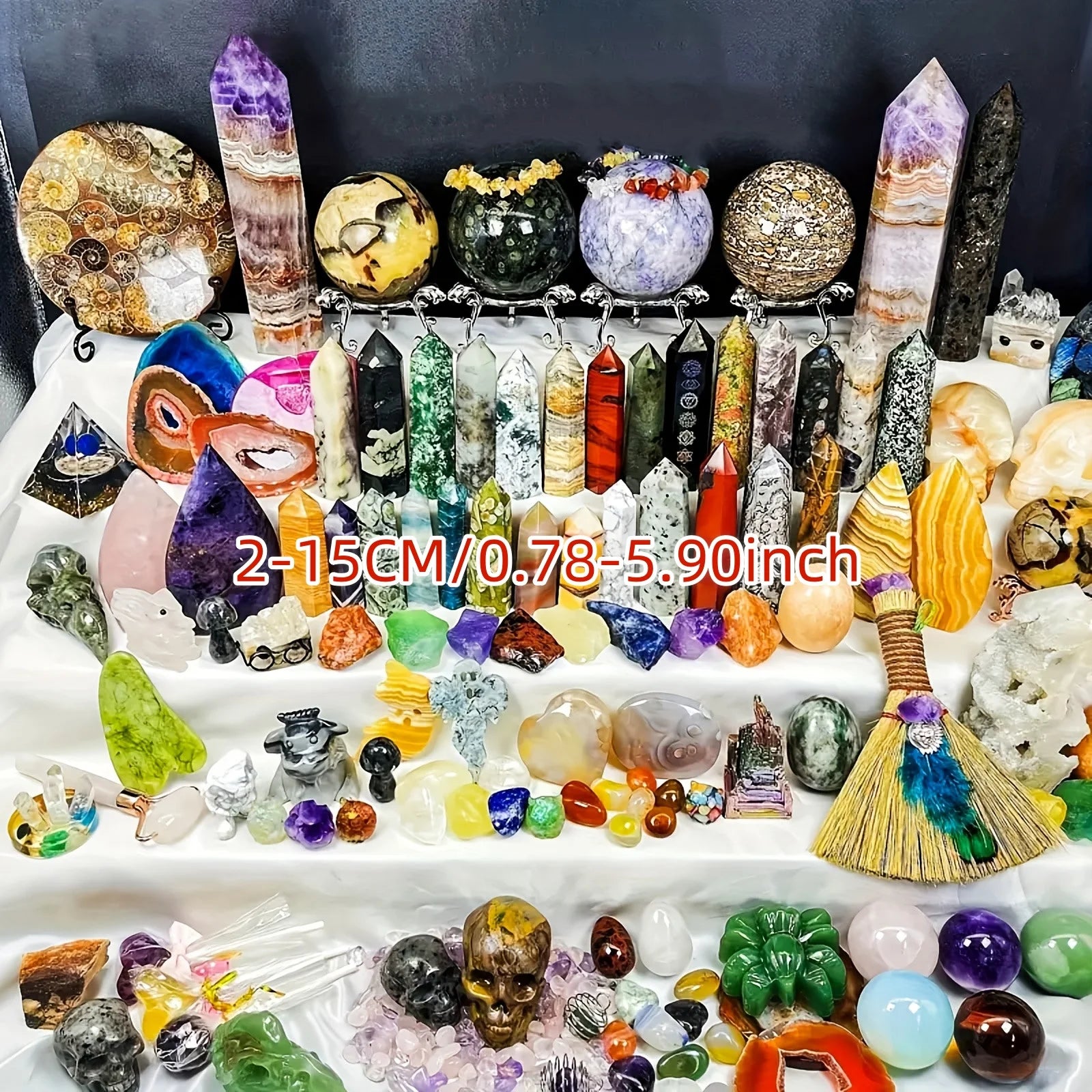 Assorted crystals and gemstones on a white surface with text indicating size range.