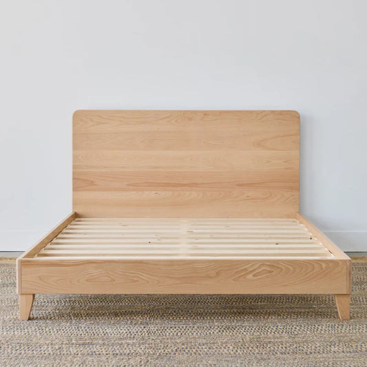 Wooden bed frame on a neutral background