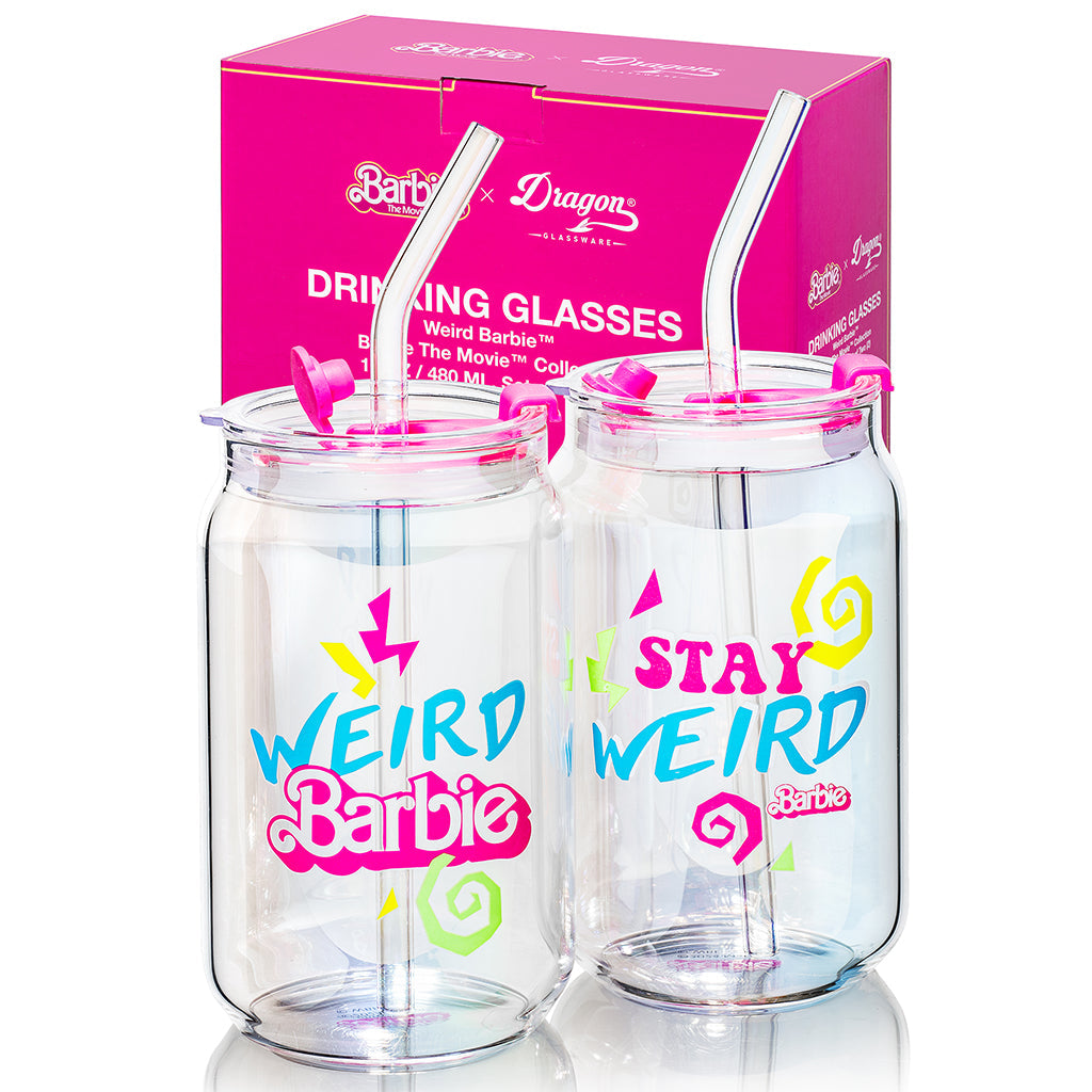 Two clear drinking glasses with colorful text and straws, featuring Barbie branding, in front of a pink packaging box.