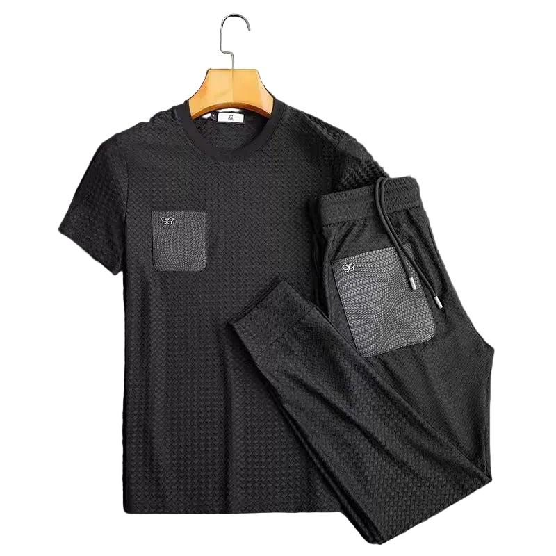 Black textured t-shirt and pants set with pockets on a dark background