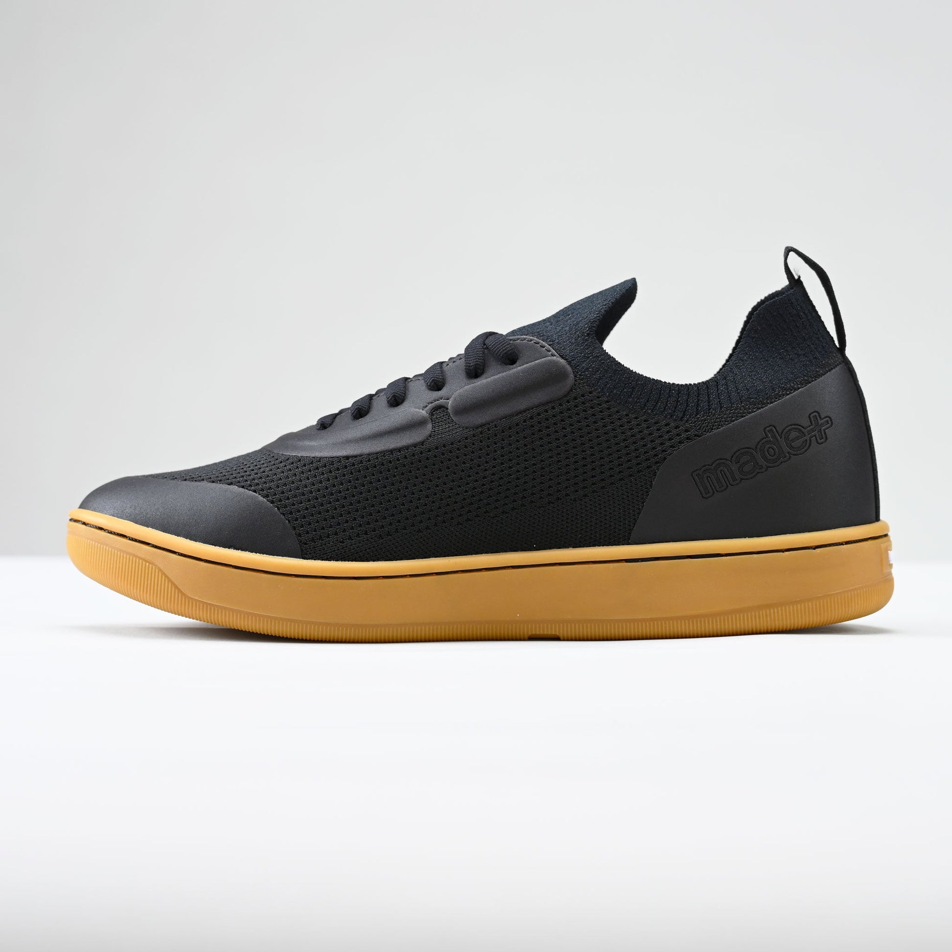 Black and yellow sneaker on a white background