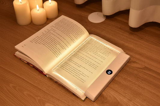 Book with a lighted cover on a wooden surface, featuring Shenzhi Tech branding.