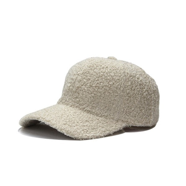Soft cream boucle sherpa teddy bear knit baseball cap with a curved brim and adjustable back closure, shown on a white background.
