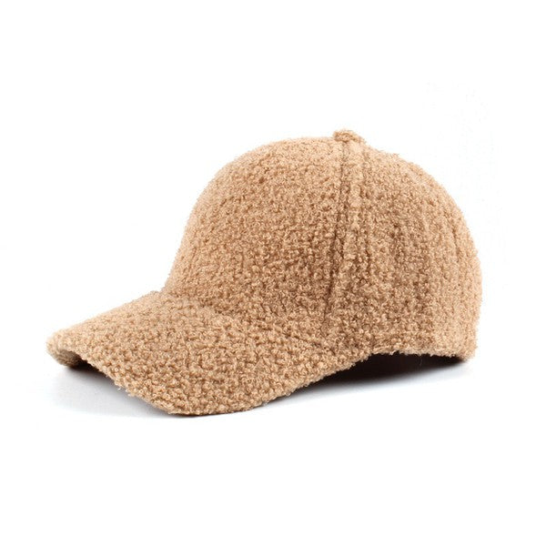 Brown boucle sherpa teddy bear knit baseball cap with a curved brim, soft textured fleece fabric, and adjustable back closure, shown on a white background.