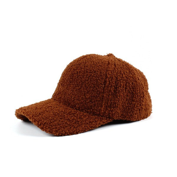Brown boucle sherpa teddy bear knit baseball cap with a curved brim, soft textured fleece fabric, and adjustable back closure, shown on a white background.