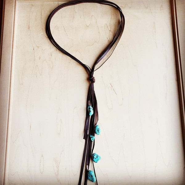 Genuine Leather Lasso Necklace
can be worn alone or layered.
Knotted in the center, the necklace slips over the head
or unknotted to adjust to suit.
Genuine Leather Tassel is approx. 12 Inches
Although your item will resemble the photo,
each piece is created by hand, so no two are identical.

Brown Lasso Necklace with Turquoise Accents