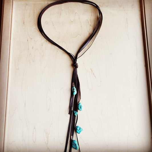 Genuine Leather Lasso Necklace
can be worn alone or layered.
Knotted in the center, the necklace slips over the head
or unknotted to adjust to suit.
Genuine Leather Tassel is approx. 12 Inches
Although your item will resemble the photo,
each piece is created by hand, so no two are identical.

Brown Lasso Necklace with Turquoise Accents