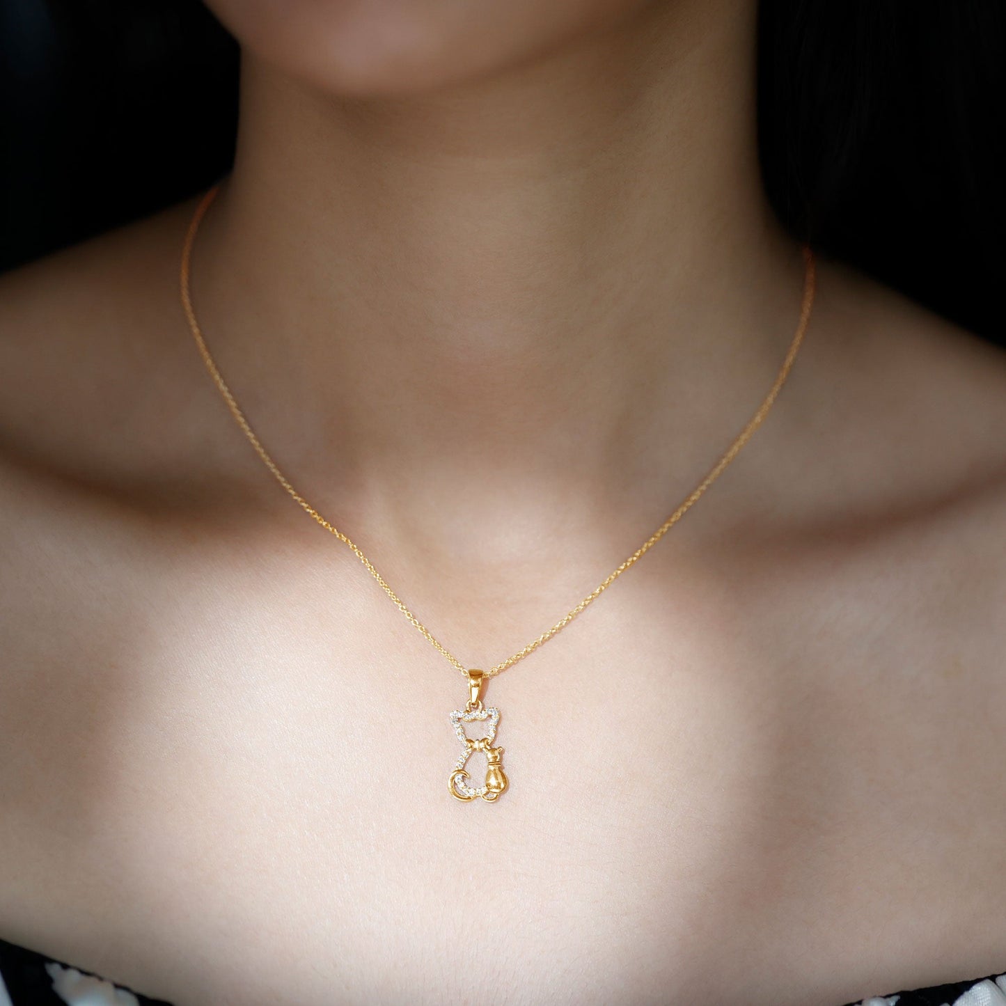Gold necklace with a cat-shaped pendant on a person's neck against a dark background Kitty Cat Necklace, Cat Pendant, Cat Lover Gift, Diamond Necklace, Diamond Pendant, Lab Diamond Necklace, Natural Diamond Necklace, Fine Jewelry, Luxury Jewelry, Sterling Silver Necklace, 10K Gold Necklace, 14K Gold Necklace, 18K Gold Necklace, White Gold Necklace, Yellow Gold Necklace, Pendant Necklace, Cat Jewelry, Animal Jewelry, Women's Jewelry, Unisex Jewelry, Gift For Her, Luxury Gift, Birthday Gift, Anniversary Gift
