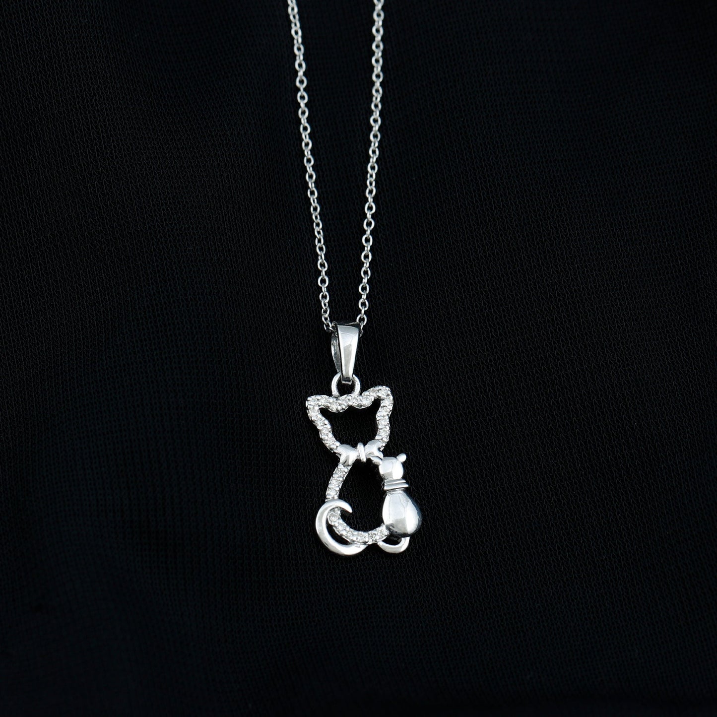 Silver cat-shaped pendant on a chain against a black background Kitty Cat Necklace, Cat Pendant, Cat Lover Gift, Diamond Necklace, Diamond Pendant, Lab Diamond Necklace, Natural Diamond Necklace, Fine Jewelry, Luxury Jewelry, Sterling Silver Necklace, 10K Gold Necklace, 14K Gold Necklace, 18K Gold Necklace, White Gold Necklace, Yellow Gold Necklace, Pendant Necklace, Cat Jewelry, Animal Jewelry, Women's Jewelry, Unisex Jewelry, Gift For Her, Luxury Gift, Birthday Gift, Anniversary Gift, Valentine's Day Gift