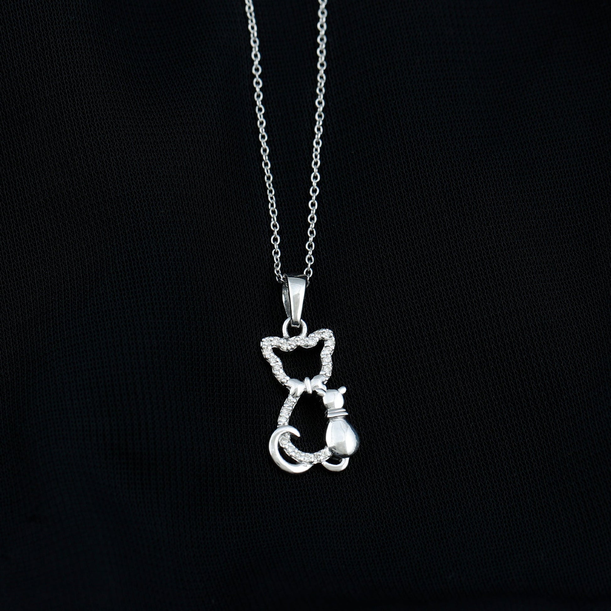 Silver cat-shaped pendant on a chain against a black background Kitty Cat Necklace, Cat Pendant, Cat Lover Gift, Diamond Necklace, Diamond Pendant, Lab Diamond Necklace, Natural Diamond Necklace, Fine Jewelry, Luxury Jewelry, Sterling Silver Necklace, 10K Gold Necklace, 14K Gold Necklace, 18K Gold Necklace, White Gold Necklace, Yellow Gold Necklace, Pendant Necklace, Cat Jewelry, Animal Jewelry, Women's Jewelry, Unisex Jewelry, Gift For Her, Luxury Gift, Birthday Gift, Anniversary Gift, Valentine's Day Gift