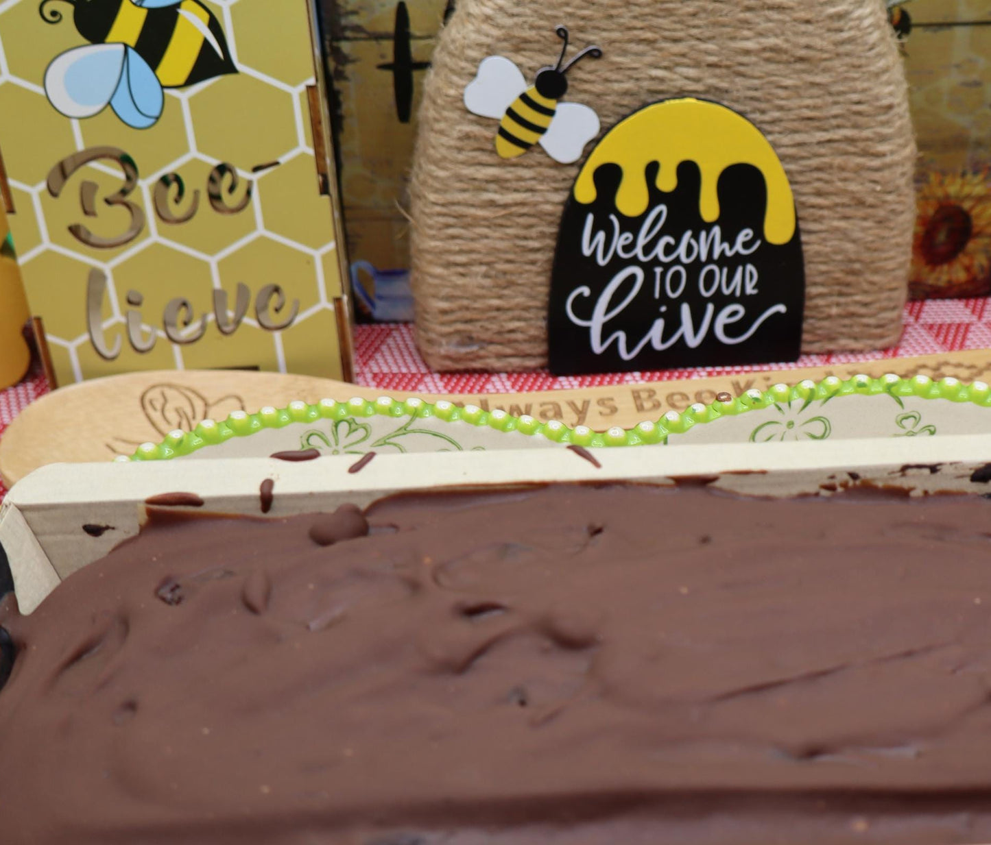Chocolate-covered dessert in a box with bee-themed decor in the background
