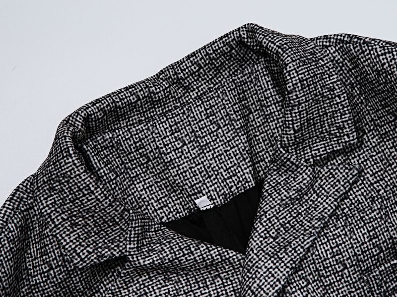 Close-up of a textured fabric with a checkered pattern on a light gray background Close-up of a textured fabric with a checkered pattern on a light gray background