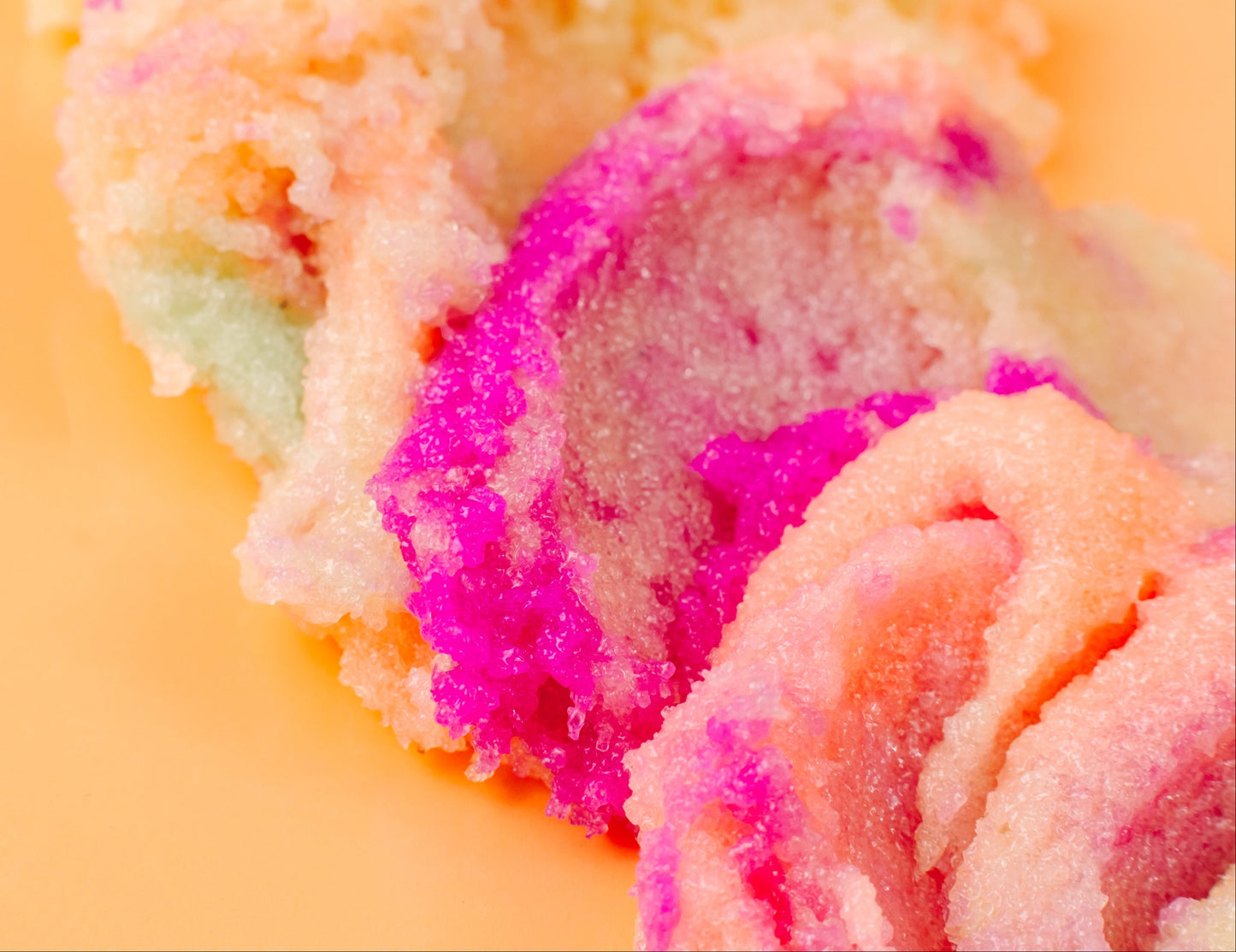 Close-up of colorful ice cream swirls on a yellow background, bath scrub sugar exfoliating body scrub