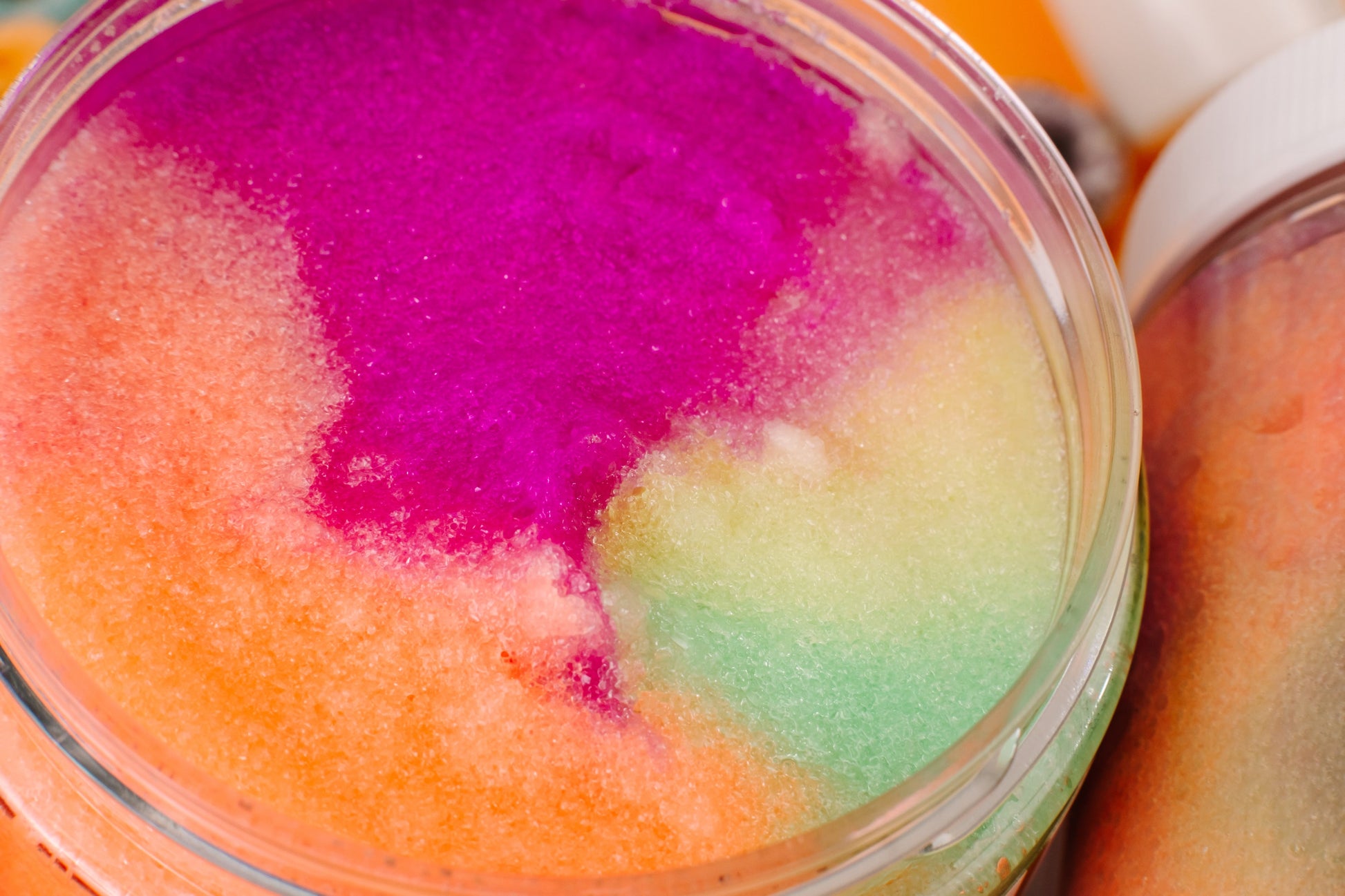 Colorful sugar scrub in a glass jar with a bottle of liquid soap in the background. Assorted beauty products including bottles and jars on a colorful background with cereal pieces. "FRUT LOOPS" BUNDLE - Bath & Body Gift Set What’s included
Whipped Body Butter • Sugar Scrub • Body Oil • Lip Gloss — a full routine for ultra-hydrated, smooth, radiant results.